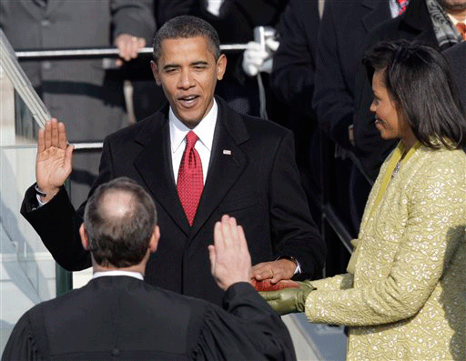 ** FOR USE AS DESIRED, YEAR END PHOTOS ** FILE - Barack Obama, left, joined by his wife Michelle, takes the oath of office from Chief Justice John Roberts to become the 44th president of the United States at the U.S. Capitol in Washington, in this Jan. 20, 2009 file photo.