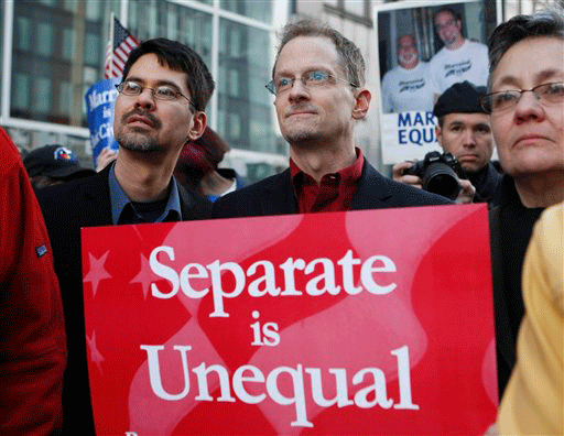 Well-known married same-sex couple Stuart Gaffney, left, and John Lewis, right, who married in 2008 and were plaintiffs in an earlier lawsuit urging the legalization of same-sex marriage, listen during a rally in front of a federal courthouse in San Francisco, Monday, Jan. 11, 2010. The first federal trial to determine if the U.S. Constitution prohibits states from outlawing same-sex marriage gets under way in San Francisco on Monday, and the two gay couples on whose behalf the case was brought 