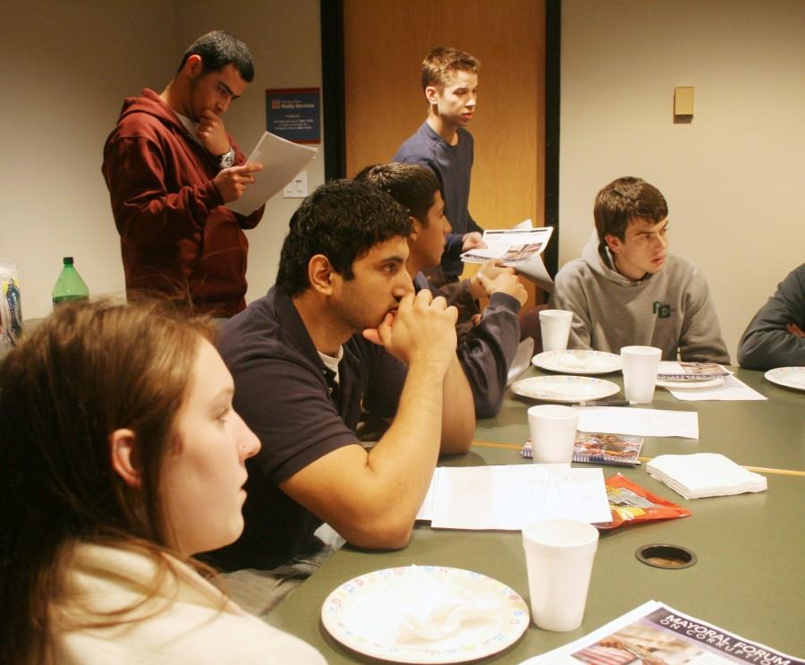 Sean Hood, a political science major, passes out fl yers at Loyola Society for Civic Engagement’s meeting Wednesday, Jan. 13 for the upcoming mayoral debate that will be held in Roussel Hall on Friday, January 15, at 7p.m.