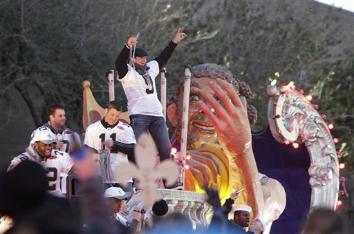 New Orleans Saints quarterback Drew Brees slautes the crowd as the team does a vicotry parade through the central business district of New Orleans, Tuesday, Feb. 9, 2010. The Saints and fans were celebrating the Saints' 31-17 victory over the Indianapolis Colts in Sunday's Super Bowl XLIV. 