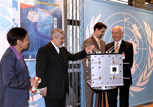 Mazlan Othman, Director of the UN Office for Outer Space Affairs, Iran's Ambassador to the International Atomic Energy Agency, IAEA, Ali Asghar Soltanieh, Saman Jalayerian member of Iran's delegation to the IAEA and Ulrich Huth Chairman of Scientific and Technical Subcommittee of the UN-Committee on the Peaceful Uses of Outer Space, from left, stand behind a model of Iran's OMID satellite during a presentation at Vienna's International Center, on Wednesday, Feb. 10, 2009. 