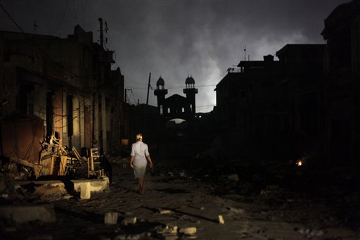 A woman walks through a damaged area in Port-au-Prince, Tuesday, Feb. 9, 2010. A powerful earthquake hit Haiti on Jan. 12. 