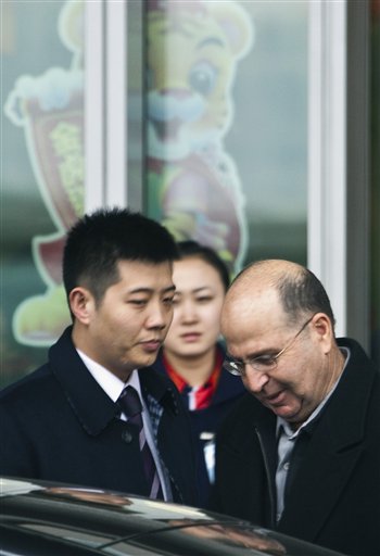 Moshe Ya'alon, right, Israel's Deputy Prime Minister, walks toward a car after arriving at the Beijing Capitol Airport in Beijing, Thursday, Feb. 25, 2010. The Israeli delegation that includes Ya'alon and central bank chief Stanley Fischer arrived in the Chinese capital, where they will hold talks with Chinese officials on topics including sanctions against Iran.