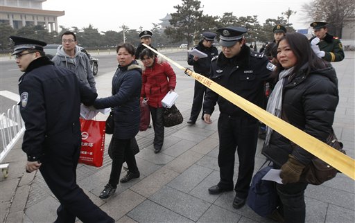 In this picture taken March. 3, 2010 show Chinese protesters are escorted away by Police official after trying to approach the Great Hall of the People in Beijing, Wednesday, March 3, 2010. Police have long tried to shush and isolate potential activists, usually starting with a low-key meeting, a warning and perhaps a drink or a meal. But now the country's troublemakers are openly blogging and Tweeting their stories about "drinking tea" with the cops and bonding like never before.