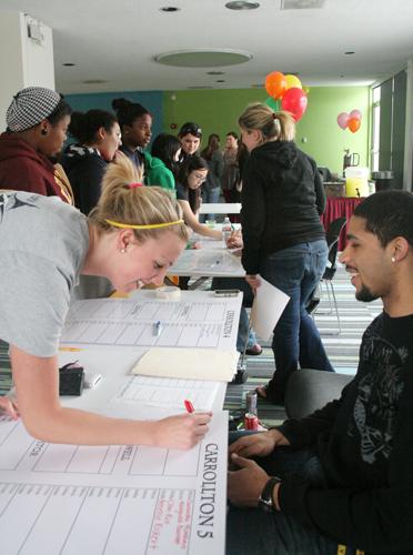 Jonuel Hernandez, finance sophomore, helps students pick out rooms Wednesday, March 24 during Room Draw. Although freshmen and sophomores are required to live on campus, juniors and seniors must weigh their options when deciding where they live next year.