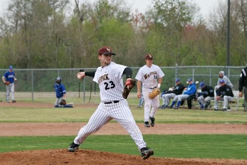 Carl Labit pitches against Faulkner University. Labit, who starts as a pitcher for many games, is often relieved by the bullpen in last minute pitching situations.
