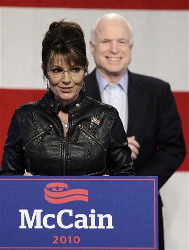FILE - In this Friday, March 26, 2010 file photo, Sarah Palin, left, talks at a campaign rally for Sen. John McCain, back, at the Pima County Fairgrounds in Tucson, Ariz. Sarah Palin and thousands of tea party activists plan to descend on Sen. Harry Reid's hometown in the Nevada desert Saturday to call for the ouster of Democrats who supported the health care overhaul.