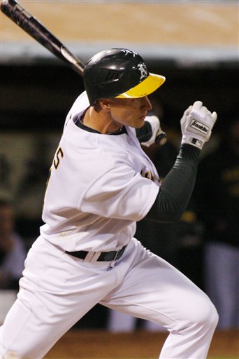 Oakland Athletics' Mark Ellis hits the game winning single against the Seattle Mariners in the tenth inning of a baseball game, Tuesday, April 6, 2010 in Oakland, Calif. The Athletics beat the Mariners 2-1. 