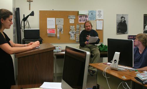 Mass communication professor Les East gives feedback to theater freshman Claire Pires on her presentation during his communications writing class Wednesday, April 7. East is one of the professors who will not be able to return next semester because of accreditation rules.