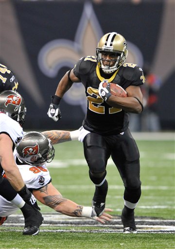 In tis Dec. 27, 2009, photo, New Orleans Saints running back Mike Bell (21) runs past Tampa Bay Buccaneers defensive tackle Chris Hovan (95) during an NFL football game in New Orleans. Bell is joining the Philadelphia Eagles. A spokesman for the Saints said the team will not match Philadelphia's offer to the restricted free-agent running back. The Saints had until midnight Tuesday, March 23, to match the Eagles' one-year offer, but vice president of communications Greg Bensel told The Associated