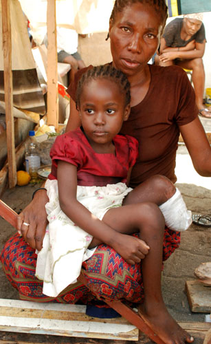 A mother cradles her daughter at Champ in Port-au-Prince, Haiti almost a month after an earthquake devasted the area Jan. 12 Haitian students will be receiving financial support from Loyola in the coming months.