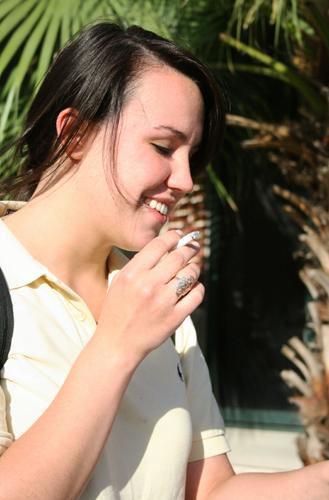 Freshman physcology major, SarahBeth Eumont, smokes a cigarette on the steps of the library Wednesday, April 28, 2010.