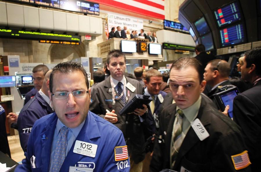 In this Aug. 27, 2010 photo, Michael Pistillo, Jr., left, with Barclays Capital, shouts out opening stock prices at the New York Stock Exchange.