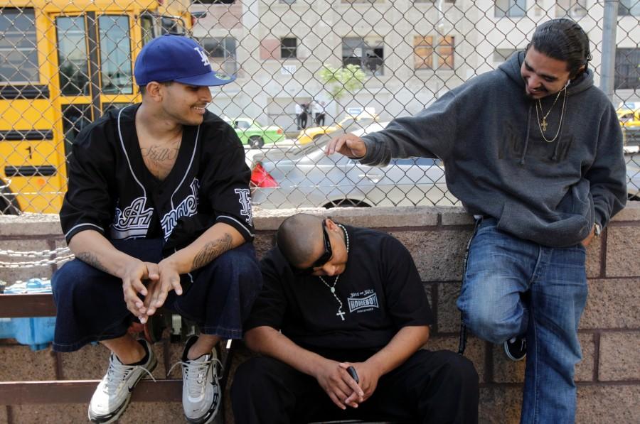 In a Monday, June 7, 2010 photo, Robert Trejo, from left, Malo Villezas and Fabian Parra jokes around outside Homeboy Industries in Los Angeles. Organizations trying to prevent youngsters from joining gangs have been hit hard by the sour economy. Homeboy Industries, which employed ex-gang members as a way of keeping them off the street, had to fire more than 300 of its workers as donations and city subsidies plummeted.