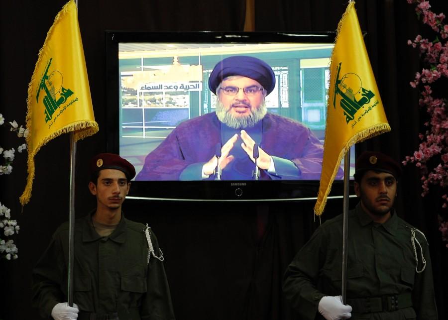 Hezbollah+fighters+stand+guard+as+Hezbollah+leader+Hassan+Nasrallah+speaks+through+a+video+link+in+the+occasion+of+Jerusalem+Day+in+the+southern+suburb+of+Beirut%2C+Lebanon%2C+Friday%2C+Sept.+3%2C+2010.+Hezbollah+leader+says+he+will+not+respond+to+a+U.N.-appointed+prosecutors+demand+for+his+group+to+hand+over+all+information+relevant+to+the+assassination+case+of+former+Lebanese+Premier+Rafik+Hariri.+Sheik+Hassan+Nasrallah+says+the+group+is+ready+to+cooperate+instead+with+the+Lebanese+judiciary.