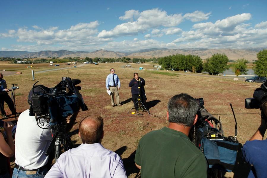 Laura McConnell, from the Rocky Mountain Incident Management Team, speaks at a briefing on the wildfire burning west of Boulder, Colo., on Thursday, Sept. 9, 2010. Rick Brough, with the Boulder County Sheriffs Department, waits to speak. Brough announced that the 8 people that were reported missing on Wednesday had been found.