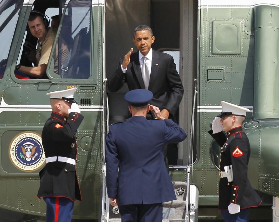 President Barack Obama salutes as he steps off Marine One helicopter.