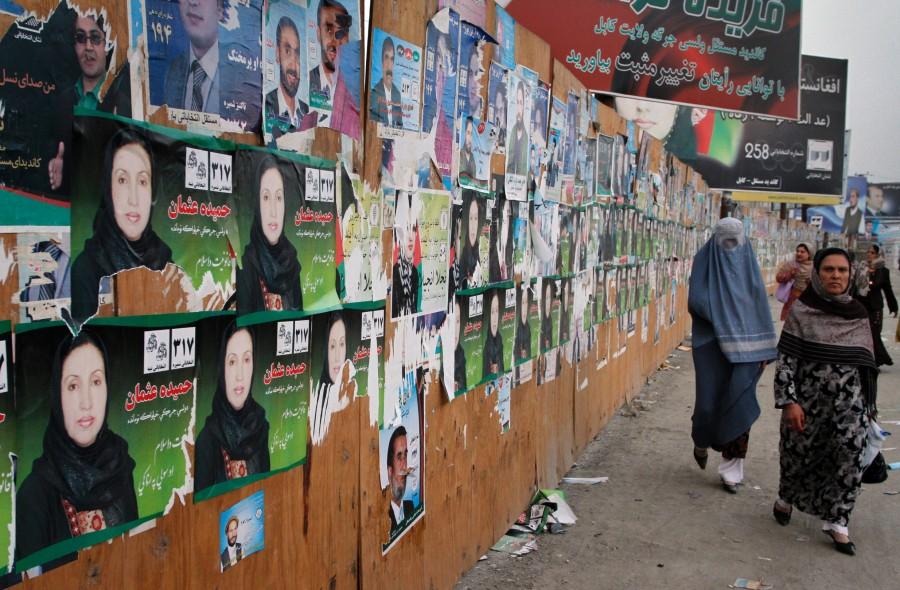 Afghan+women+walk+past+by+election+posters+of+parliamentary+candidates+in+Kabul%2C+Afghanistan%2C+Wednesday%2C+Sept.+15%2C+2010.+Afghans+will+choose+249+members+of+the+lower+house+from+among+more+than+2%2C500+candidates+on+Sept.+18.
