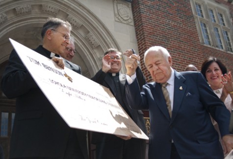 The Rev. Ted Dziak, S.J. holds a check for $8 million from Tom Benson, New Orleans Saints’ owner. The ceremony, Thursday Sept. 23 revealed that the donation is for renovating the old library.