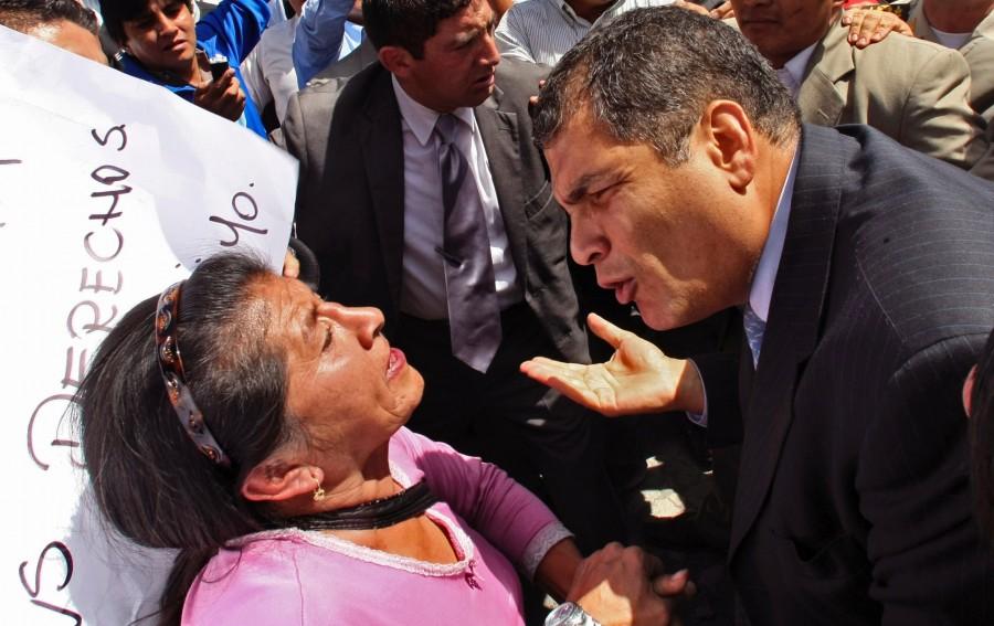 Ecuadors President Rafael Correa, right, speaks to a demonstrator during a protest of police officers and soldiers against a new law that cuts their benefits at a police base in Quito, Ecuador, Thursday, Sept. 30, 2010. Hundreds of police protesting the new law plunged the country into chaos on Thursday, shutting down airports and blocking highways in a nationwide strike.