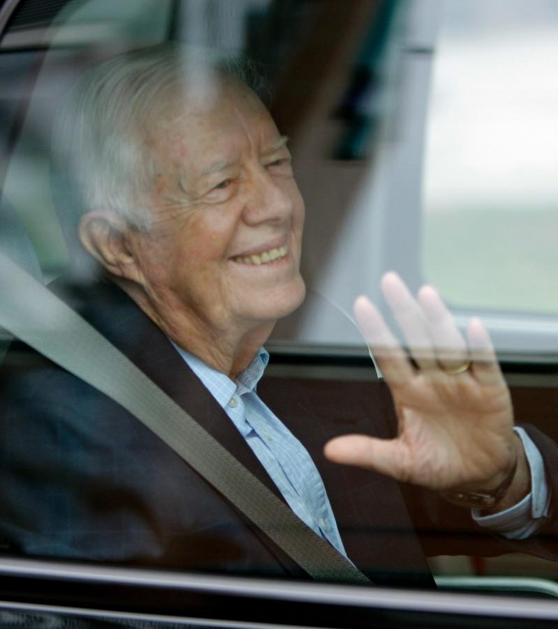 Former President Jimmy Carter waves from a vehicle as he leaves MetroHealth Hospital Thursday, Sept. 30, 2010, in Cleveland. Carter left the hospital where he spent two days recovering from a viral infection doctors say likely gave him stomach problems.