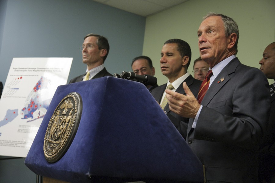n this photo provided by the Mayor's office, New York City Mayor Michael Bloomberg, right, and New York Gov. David Paterson, center, attend a news conference to unveil an initiative excluding sugar-sweetened beverages from food stamp purchases Thursday, Oct. 7, 2010, in the Brooklyn borough of New York. Bloomberg and Paterson announced Thursday that they are seeking permission from the U.S. Department of Agriculture to add sugary drinks to the list of prohibited goods.