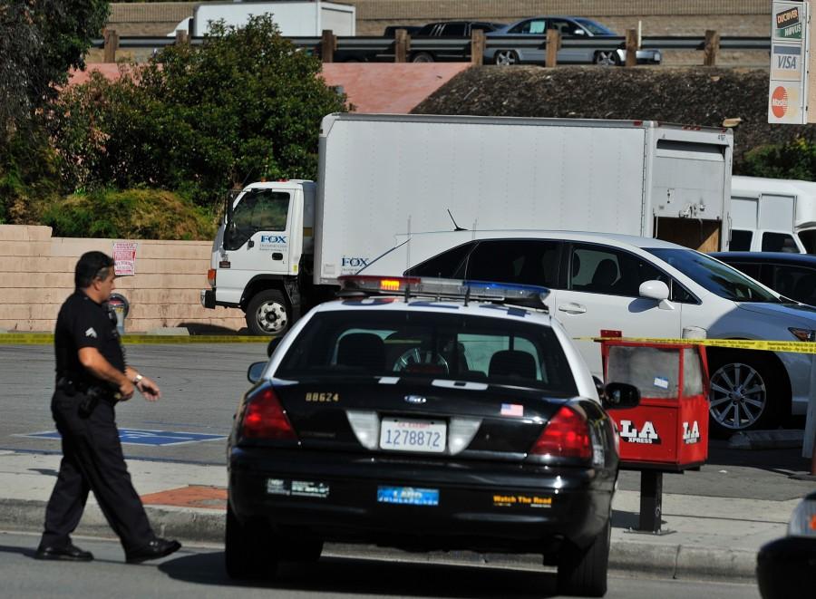 LAPD officers investigate the scene where a delivery truck that was used to deliver drugs to a Rite Aid store was recovered, Thursday, Oct. 7, 2010 in Tarzana, Calif.. Authorities say they have found a pharmaceutical delivery man and his stolen truck after he was kidnapped by suspects impersonating police officers. 