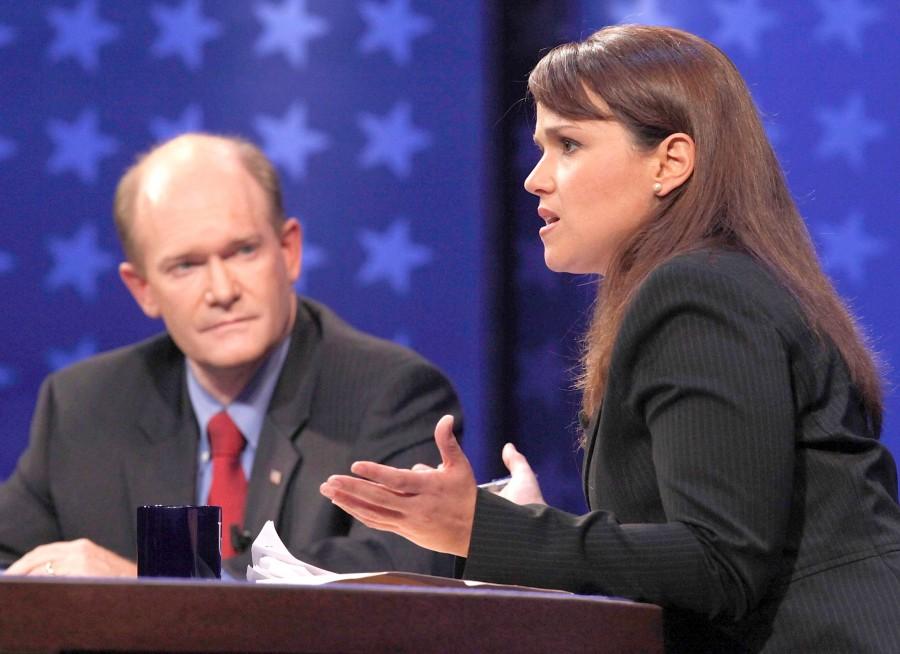FILE - In this Oct. 13, 2010 file photo, Delaware Republican Senate candidate Christine O'Donnell answers a question as Democratic candidate Chris Coons listens at left, during a televised Delaware Senate debate at the University of Delaware in Newark, Del. 