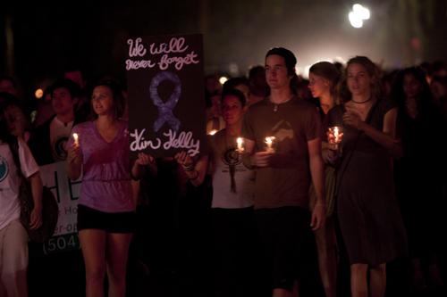 Loyola and Tulane students walk down St. Charles Ave. with posters and candles during the Take Back the Night march.