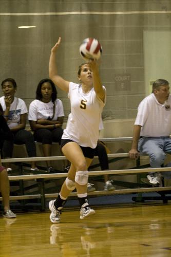 Political science sophmore Samantha Worsham gets ready to serve in a game against Spring Hill University. The team is set to play the University of New Orleans on Oct. 30.