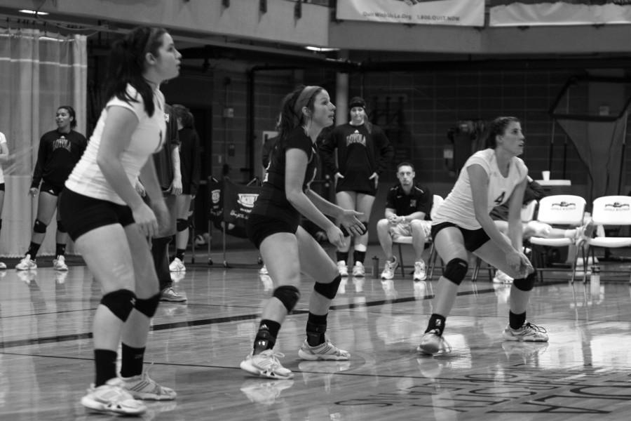 Volleyball players get ready to return a serve during a recent game. The team is gearing up for conference play.