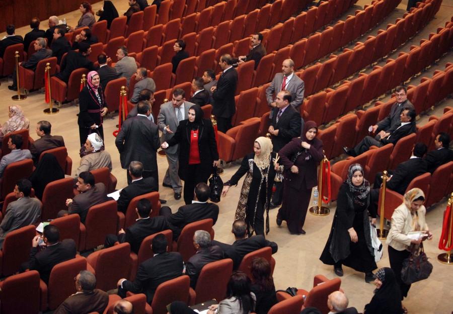 Members of his Sunni-backed coalition are seen as they walk out of of Iraq's parliament session in a protest before a vote on the presidency in Baghdad, Iraq, Thursday, Nov. 11, 2010. 