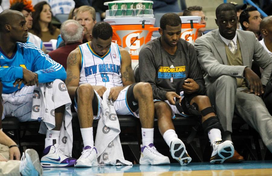 From left, New Orleans Hornets’ Emeka Okafor, Marcus Thornton, Chris Paul and Pops Mensh-Bonsu sit on the bench during a home game against the Los Angeles Lakers. The game drew 18,018 fans, raising the Hornets’ average close to their goal of 14,309 per game. The current average is 14,085 fans per game. 