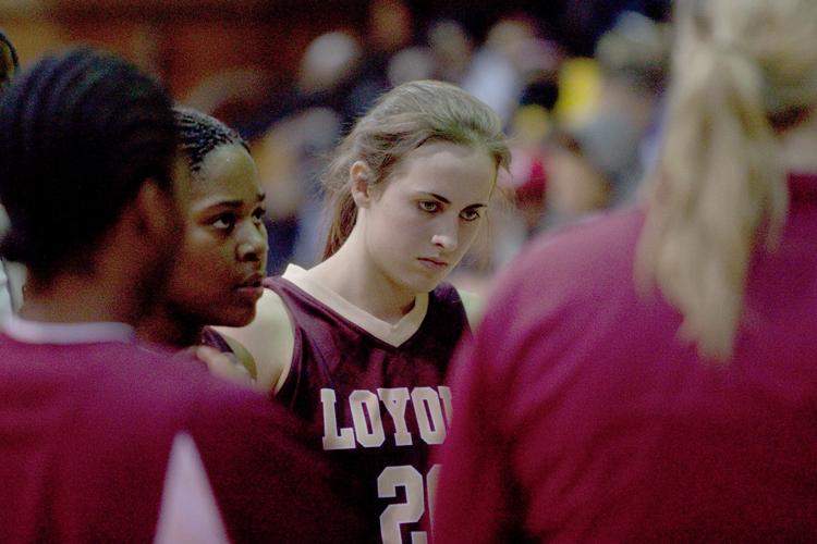 Loyola women’s basketball player, No. 20 Amy Moody, listens to head coach Kellie Kennedy during a group huddle. The Lady Wolfpack trailed the Gold Rush for nearly the entire game.
