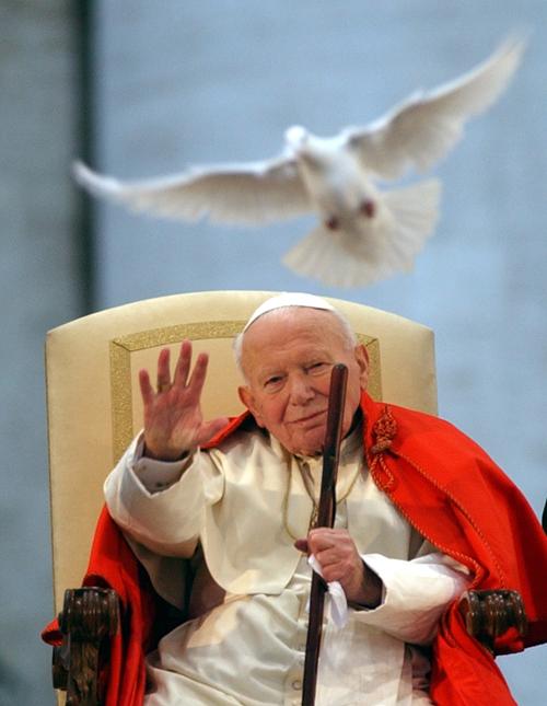 Pope John Paul II watches the flight of a dove symbolizing peace.  Pope Benedict XVI is set to beatify John Paul II on May 1.