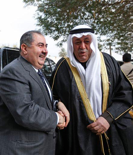 Kuwaiti ambassador Ali Mohammed al-Moumin, right, and Iraqi Foreign Minister Hoshyar Zebari shake hands during a flag-raising ceremony at the new Kuwaiti Embassy in the heavily guarded Green Zone in Baghdad, Iraq, Wednesday, Jan. 26, 2011. Iraq and Kuwait pledged Wednesday to work toward resolving border disputes and debt issues as the two former enemies seek to repair relations damaged by Saddam Hussein's 1990 invasion of the oil-rich emirate. 