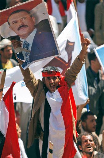 A supporter of Yemeni President Ali Abdullah Saleh shouts while holding his portrait during a rally in support of Saleh in Sanaa, Yemen, Wednesday, Feb. 2, 2011. The Yemeni president told parliament on Wednesday that he will not seek another term in office or hand power to his son ¡n an apparent reaction to protests in this impoverished nation that have been inspired by Tunisia's revolt and the turmoil in Egypt.