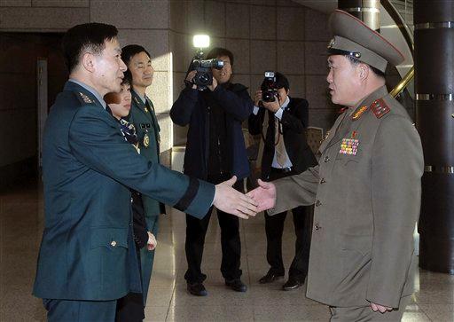 n this photo released by the Defense Ministry, North Korean Army Col. Ri Sun Gyun, right, shakes hands with South Korean counterpart Col. Moon Sang-gyun upon his arrival for their military meeting at the south side of the truce village of Panmunjom in the demilitarized zone (DMZ) that separates the two Koreas since the Korean War, north of Seoul, South Korea, Wednesday, Feb. 9, 2011. South Korea agreed Wednesday to hold talks with North Korea on humanitarian issues between the rivals, as militar