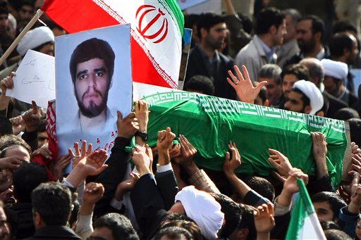 Pro-government Iranians carry the flag-draped coffin of Sane Jaleh, seen in picture at left, a student who was killed during Monday's clashes, in a funeral ceremony in Tehran, Iran, Wednesday, Feb. 16, 2011. Iran's state TV described Jaleh a government supporter and a member of the paramilitary Basij, part of the Guard forces that have cracked down on protesters. But the reformist website kaleme.com called him a member of election campaign of opposition leader Mir Hossein Mousavi. Clashes betwee