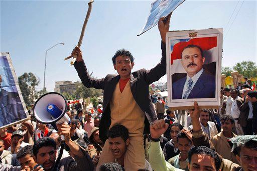 Supporters of the Yemeni government shout slogans as they try to enter Sanaa University where anti-government protestors gather, in Sanaa, Yemen, Wednesday, Feb. 16, 2011. Yemen sent 2,000 policemen into the streets of the capital on Wednesday to try to put down days of protests against the president of 32 years, a key U.S. ally in battling al-Qaida.The policemen, including plainclothes officers, fired in the air and blocked thousands of students at Sanaa University from joining thousands of oth