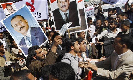 Yemeni anti-government protestors, right, scuffle with government supporters during a rally demanding political reform and the resignation of President Ali Abdullah Saleh in Sanaa, Yemen, Sunday, Feb. 13, 2011. Yemeni police have clashed with anti-government protesters demanding political reform and the resignation of President Ali Abdullah Saleh. Several thousand protesters, many of them university students, tried to reach the central square in the capital of Sanaa on Sunday, but were pushed ba