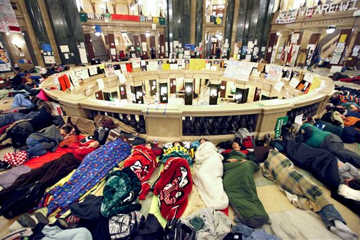 Opponents of Wisconsin Governor Scott Walker's budget bill sleep in the rotunda of the Wisconsin State Capitol Tuesday, Feb. 22, 2011.