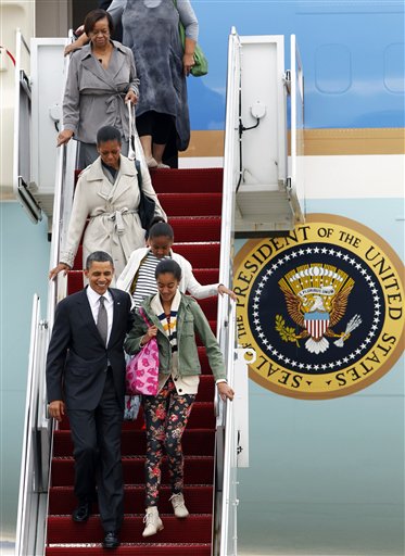 President Barack Obama arrives from a Latin America tour with his family, front right to back, daughters Malia and Sasha, first lady Michelle Obama, and mother-in-law Marian Robinson, at Andrews Air Force Base, Md., Wednesday, March 23, 2011. 