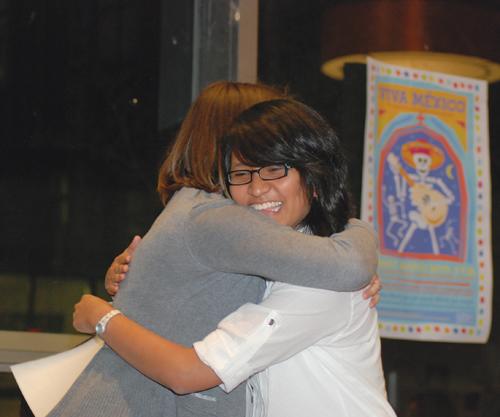 Forensic chemistry junior Inna Dizon hugs a friend after winning a $1,000 International scholarship. The Center for International Education hosted its annual banquet March 25. 