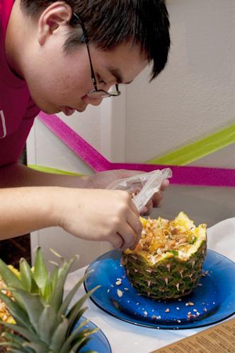 Johnathan Lam, biology freshman,  puts some finishing touches on a pineapple dish.  Loyola Asian Student Organization hosted the 2011 Iron Chef competition in the St. Charles Room on April 12. 