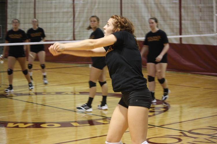 General studies freshman and defensive specialist Rachael Lopez bump passes during a full set practice.