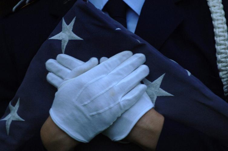 A member of the ROTC holds a flag after a ceremony. The ROTC commissions students to become officers in divisions of the military.