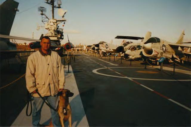 David Aviles stands with his dog Pasja on an aircraft carrier in New York. Aviles and Pasja helped in rescue efforts in the days after the collapse of the Twin Towers, and later helped the FBI track down hijackers.