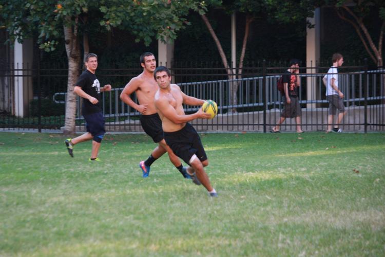 Finance senior Alex Weed moves the ball during rugby practice in the residential quad on Aug. 31. The team practices weekdays at 6 p.m.