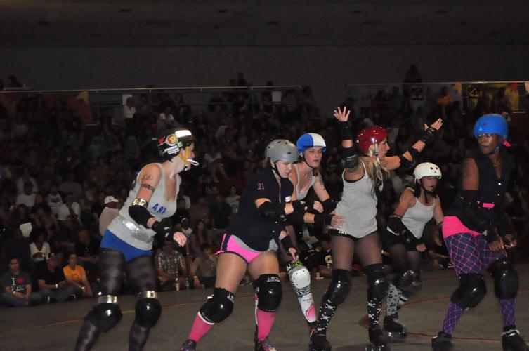 Brooke Ethridge, second from the left, rounds the track during the Home Double Header. Ethridge's team, the Cresent Wenches, faced off against the Acadiana Good Times from Lafayette, La.